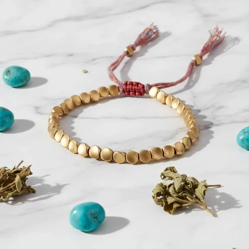 Free spirited journey — tibetan golden bracelet with highland snow mountains