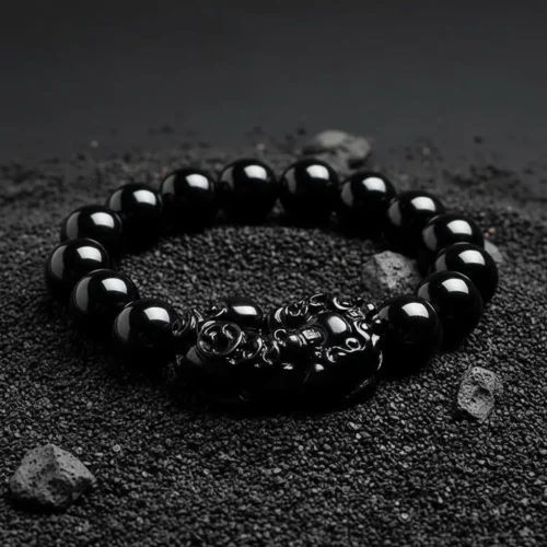 Black obsidian pixiu bracelet on volcanic rock
