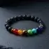 Chakra energy bracelet product close up on dark stone background