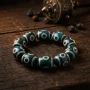 Green Turquoise Nine Eye Dzi Bracelet with Antique Prayer Wheel Green turquoise nine eye dzi bracelet with antique prayer wheel
