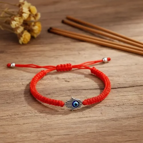 Hamsa evil eye bracelet on rustic wooden background
