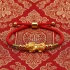 Traditional pixiu bracelet on tibetan brocade fabric background