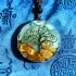 Tree of life orgone pendant on traditional tibetan blue brocade fabric