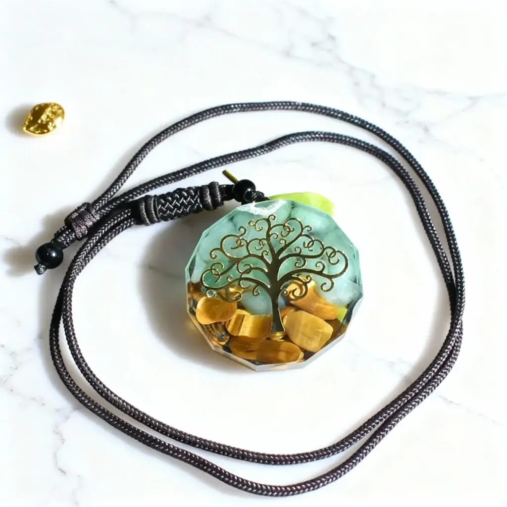 Tree of life pendant with tiger eye stones on marble background