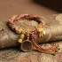 Tibetan prayer wheel bracelet on traditional buddhist brocade fabric