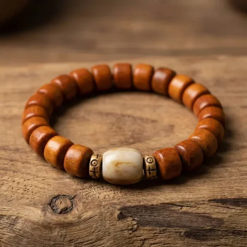 Tibetan yak bone mala bracelet on rustic wood background