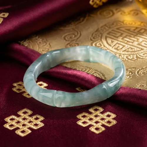 Jade ring tibetan buddhist symbols burgundy gold fabric