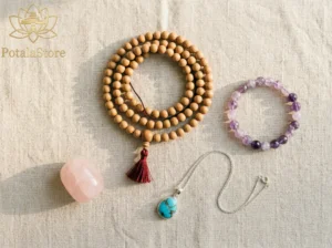 A flat lay of spiritual jewelry including mala beads, crystal bracelets, and a turquoise pendant arranged on natural linen — spiritual jewelry for inner peace from PotalaStore