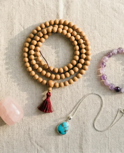spiritual-jewelry-inner-peace-guide-potalastore A flat lay of spiritual jewelry including mala beads, crystal bracelets, and a turquoise pendant arranged on natural linen — spiritual jewelry for inner peace from PotalaStore