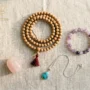 spiritual-jewelry-inner-peace-guide-potalastore A flat lay of spiritual jewelry including mala beads, crystal bracelets, and a turquoise pendant arranged on natural linen — spiritual jewelry for inner peace from PotalaStore