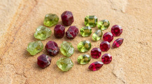 Peridot and ruby gemstones side by side, representing the primary birthstones for Leo zodiac sign