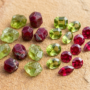 Leo Birthstone Peridot and Ruby Gemstones Peridot and ruby gemstones side by side, representing the primary birthstones for Leo zodiac sign