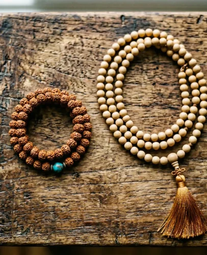 Wrist Mala Bracelet vs Full 108-Bead Mala Necklace Comparison Side-by-side comparison of a Tibetan wrist mala bracelet with 27 beads and a full 108-bead mala necklace on a wooden meditation surface