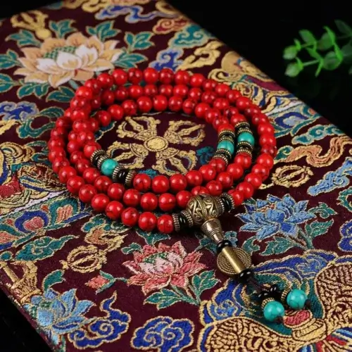 Handmade Tibetan mala 108 red turquoise beads coiled on traditional Tibetan brocade fabric with brass ornament