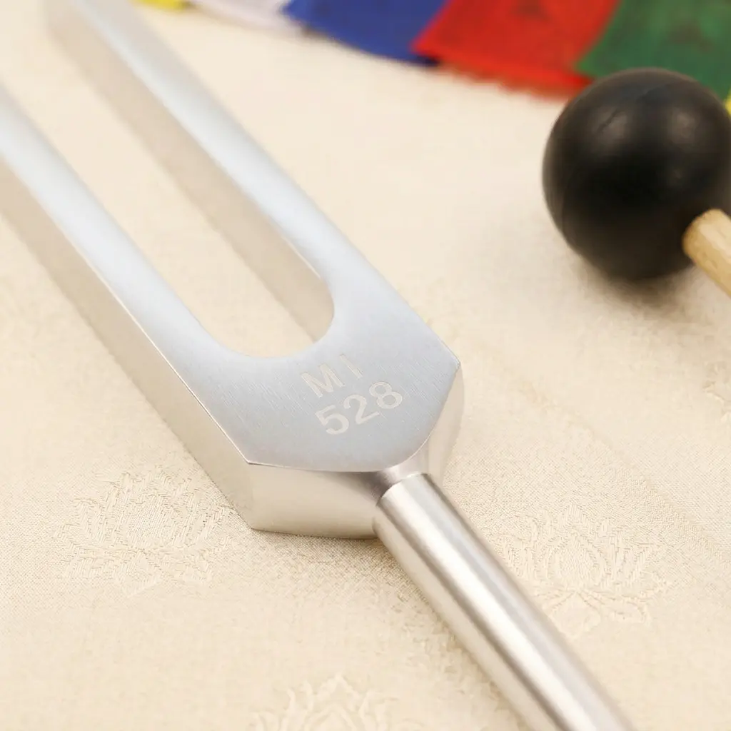 528 Hz MI Solfeggio Tuning Fork – Precision Engraved Aluminum Alloy PotalaStore Close-up of a 528 Hz aluminum alloy tuning fork engraved with MI 528, the Solfeggio Love Frequency, with a rubber mallet — PotalaStore sound healing tool