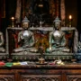 Buddha Statue Selection Guide – Pose, Material and Purpose A collection of four bronze Buddha statues displaying different mudras — Dhyana, Abhaya, Bhumisparsha, and Medicine Buddha — arranged on a wooden altar with soft candlelight