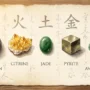 Feng Shui Wealth Stones Guide Five feng shui wealth stones laid out on aged parchment: black obsidian, golden citrine, green jade, pyrite cube, and green aventurine, each labeled with its feng shui element