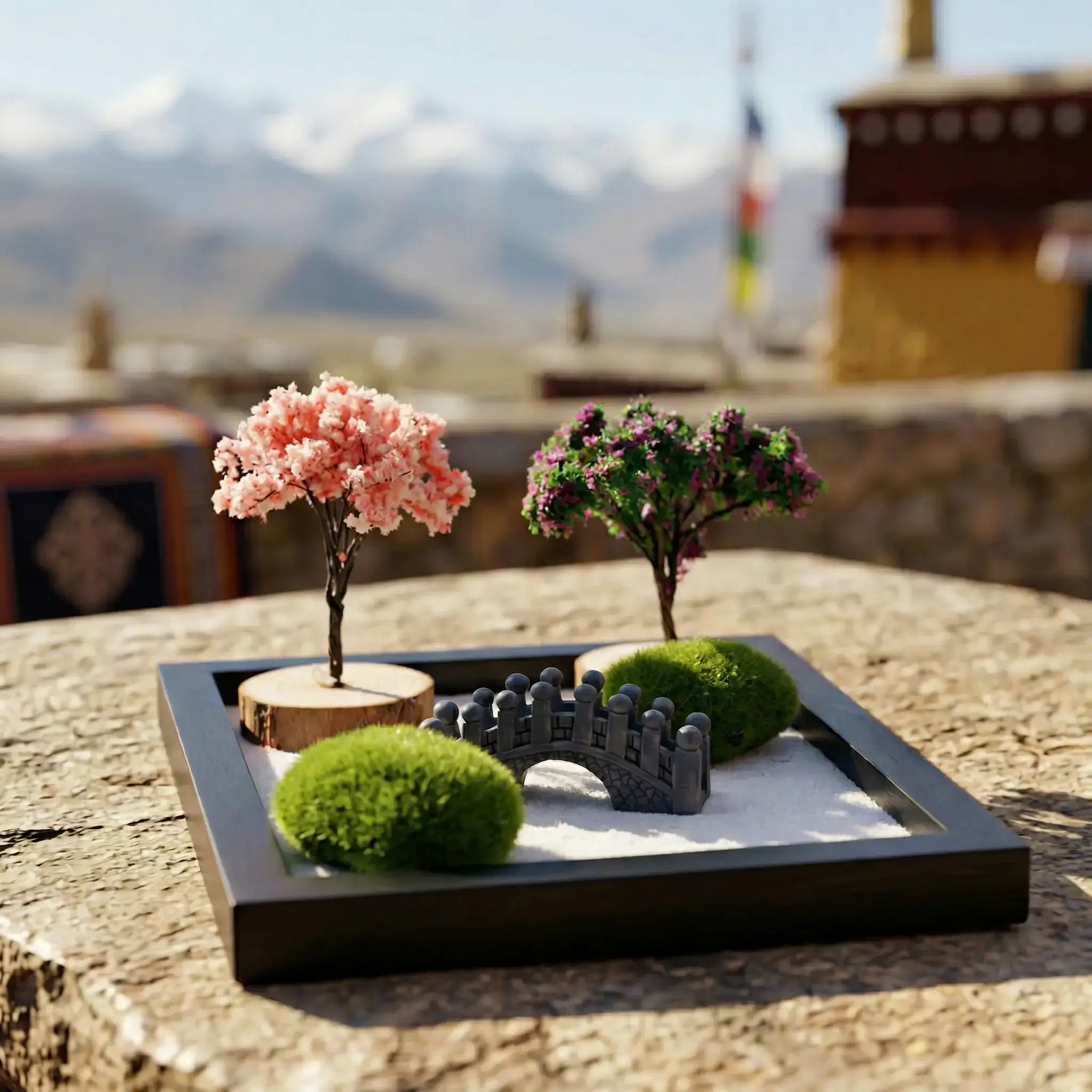 Miniature Zen Garden Kit on Tibetan Monastery Rooftop – PotalaStore Buddha zen garden kit for desk displayed on a stone surface at a Tibetan monastery, with prayer flags, a golden stupa, and snow-capped Himalayan mountains in the background — PotalaStore