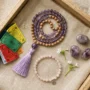 Spiritual Easter Gift Guide 2026 Spiritual Easter gift flat lay featuring rose quartz bracelet, amethyst tumbled stones, 108-bead mala necklace, and Tibetan prayer flags arranged on natural linen
