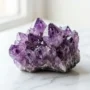 A deep purple amethyst crystal cluster with natural color zoning and vitreous luster, used as a healing stone for meditation and stress relief