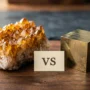 Citrine vs Pyrite Wealth Crystals Side by Side Comparison Citrine cluster and pyrite cube placed side by side on a wooden surface for wealth attraction comparison
