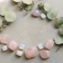 222-angel-number-crystals-rose-quartz-moonstone 222 angel number displayed beside rose quartz and moonstone crystals on a soft pink surface