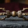 Five-Pronged Dorje Vajra Close-up A five-pronged dorje (vajra) ritual implement made of bronze, showing the central sphere, lotus bases, and five prongs on each │ │ │ end — the most common form used in Tibetan Buddhist ceremonies