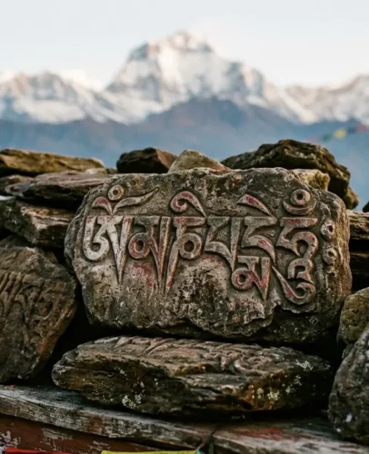 Om Mani Padme Hum Mantra Carved in Tibetan Script Om Mani Padme Hum mantra carved in Tibetan script on weathered mani stones in the Himalayas