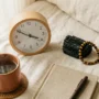 Seeing 4_44 — the 444 angel number and grounding crystals (2) Clock showing 4:44 beside black tourmaline and tiger's eye crystals on warm linen