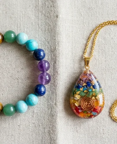 Chakra Bracelet vs Chakra Necklace Comparison Seven-stone chakra bracelet and rainbow chakra pendant necklace displayed side by side on light linen