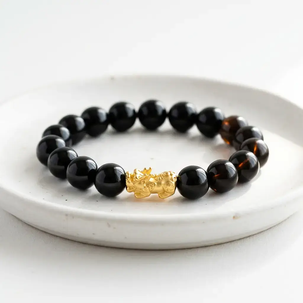 Close-up illustration of a black obsidian Pixiu bracelet showing light translucency test and stone texture, used to distinguish authentic Tibetan bracelets from fakes
