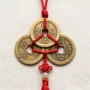 Three Feng Shui Coins on Red String Three Chinese feng shui coins tied together on a red string representing the trinity of Heaven, Earth, and Humanity