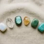 best-crystals-for-new-beginnings-flatlay Six crystals for new beginnings arranged on linen: moonstone, clear quartz, labradorite, citrine, green aventurine, and amazonite