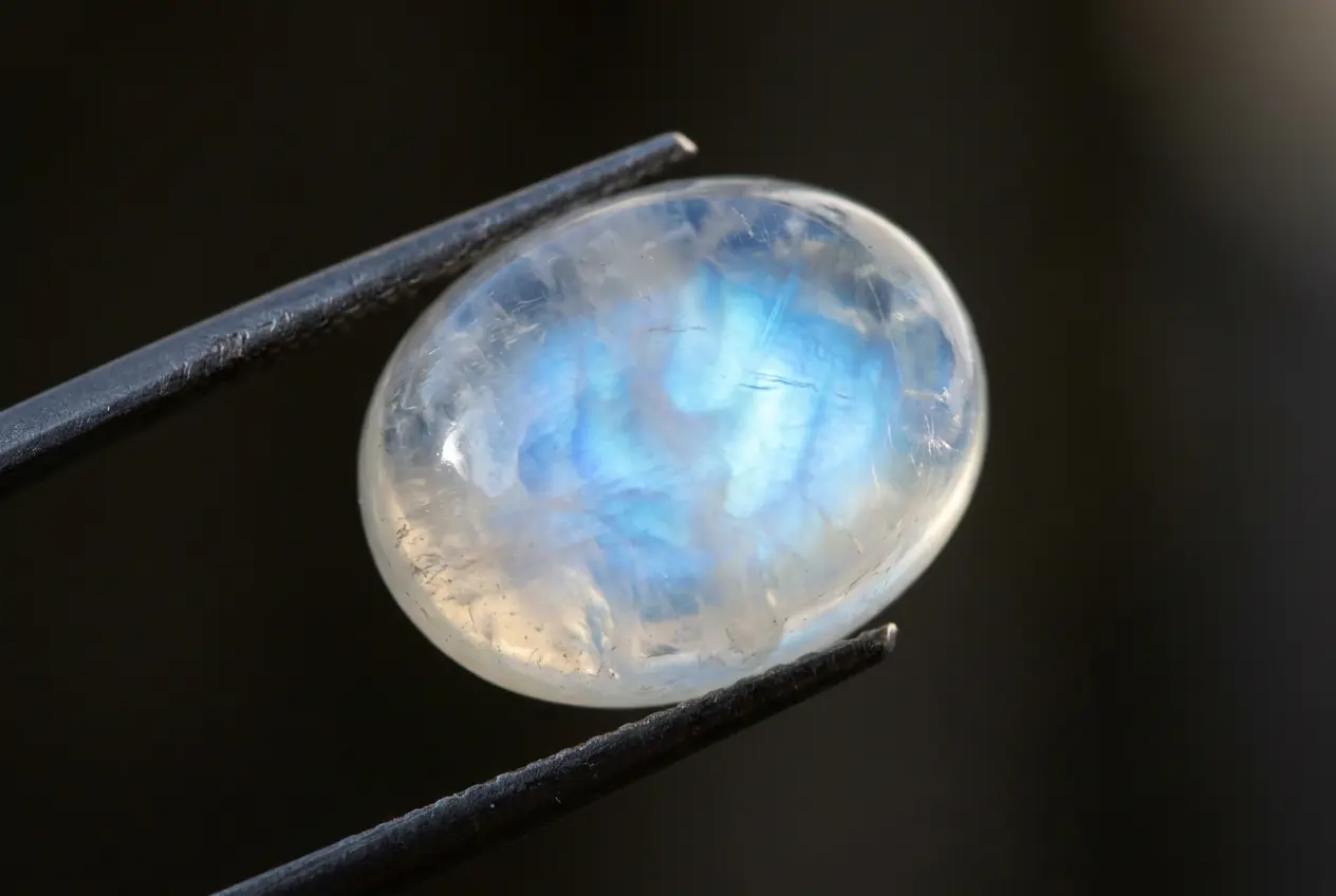 Close-up of a moonstone showing its blue adularescence glow, the classic stone of new beginnings