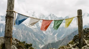 Weathered five-color Tibetan prayer flags fading on a string, showing when to respectfully dispose of old prayer flags