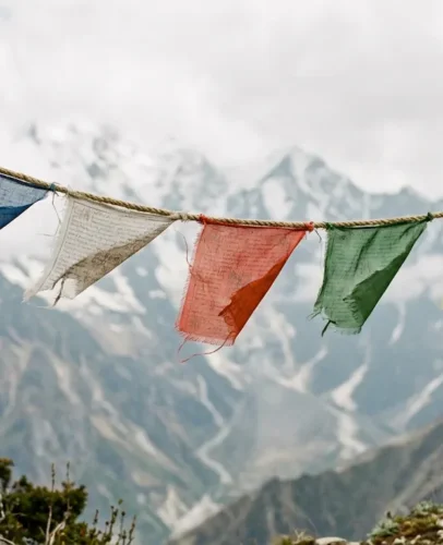 old-tibetan-prayer-flags-weathered Weathered five-color Tibetan prayer flags fading on a string, showing when to respectfully dispose of old prayer flags