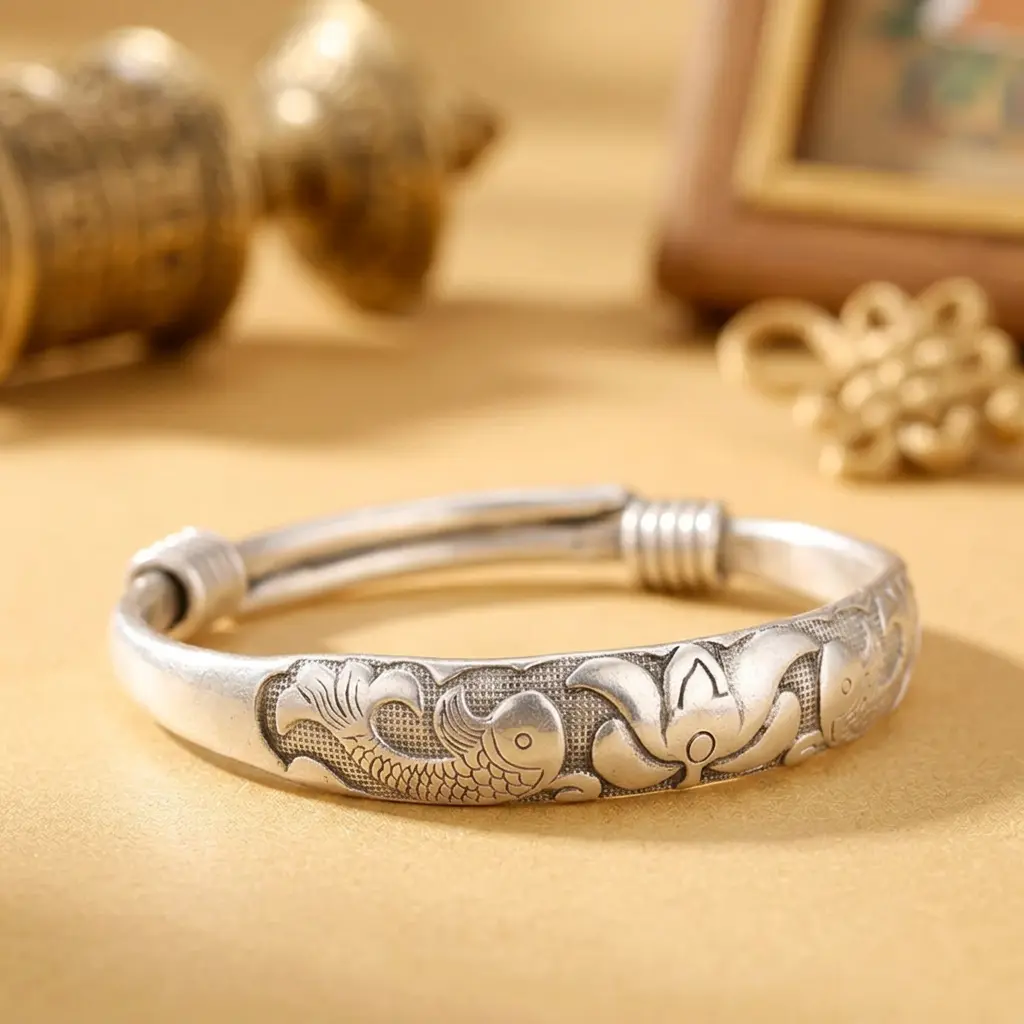 tibetan-embossed-bracelet-double-fish-lotus Tibetan handmade embossed bracelet with double fish and lotus motif on an adjustable white copper and silver open cuff