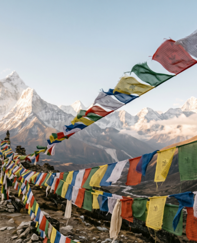 tibetan-prayer-flags-mountain-pass Colorful Tibetan prayer flags in blue, white, red, green, and yellow strung across a Himalayan mountain pass