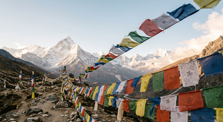 tibetan-prayer-flags-mountain-pass Colorful Tibetan prayer flags in blue, white, red, green, and yellow strung across a Himalayan mountain pass