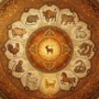 october-2027-chinese-zodiac-horoscope-hero Illustrated Chinese zodiac wheel for the October 2027 horoscope, showing the twelve zodiac animals encircling a Metal Dog in autumn gold and rust tones within the Fire Goat year