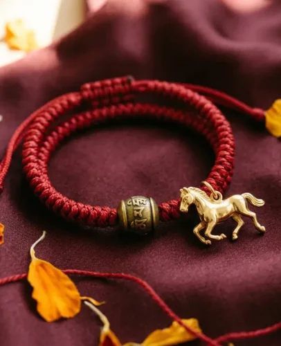 Red string bracelet with a gold horse charm, worn to protect a Benming Nian zodiac year in 2026