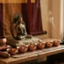 buddhistický-domácí-oltář-rituální-předměty.jpg Buddhistický domácí oltář se sochou Buddhy, sedmi obětními mísami, kadidlem a malou zpívající mísou
