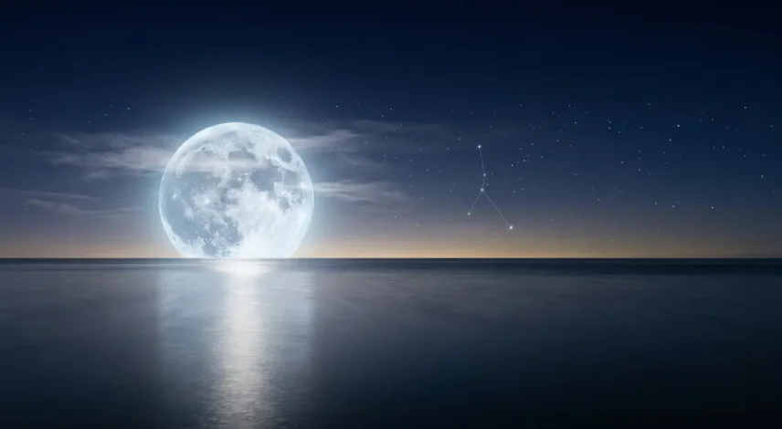 Luminous full moon reflected on calm water in a starry indigo sky, symbolizing the Cancer 2027 horoscope