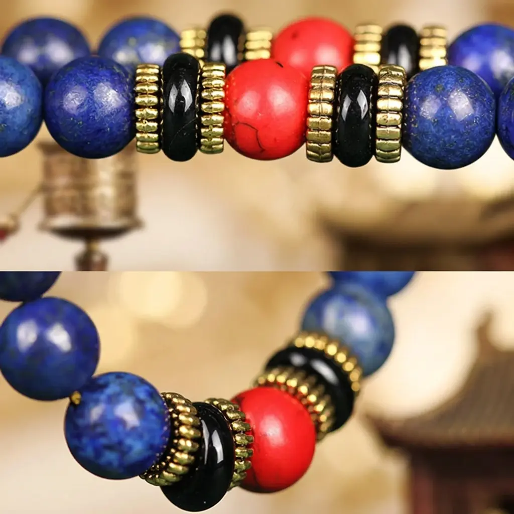 lapis-lazuli-mala-close-up-red-turquoise-black-agate-spacers Close-up of natural lapis lazuli mala beads with red turquoise, black agate and gold-tone spacer rings